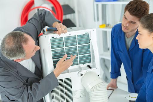 Our senior technician giving a lesson in HVAC services to junior technicians at a client’s house in Jefferson Parish